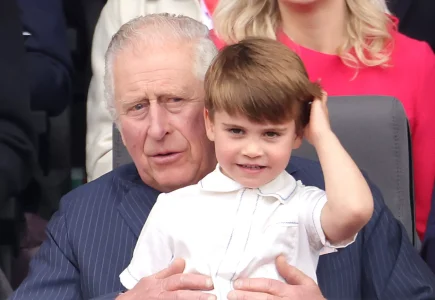 King Charles walking hand in hand with Princess Charlotte
